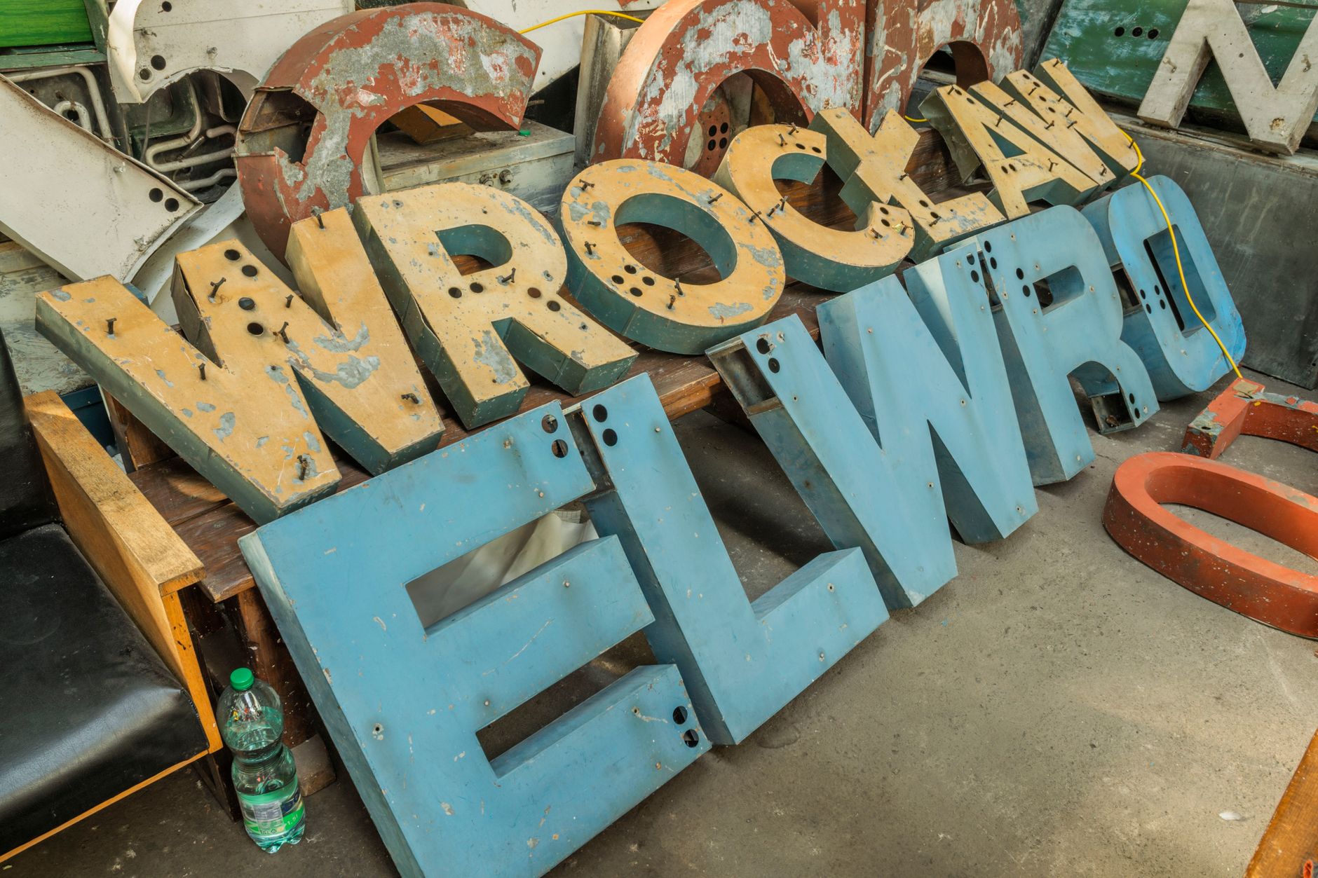 Collection of worn vintage neon letters at an industrial workshop